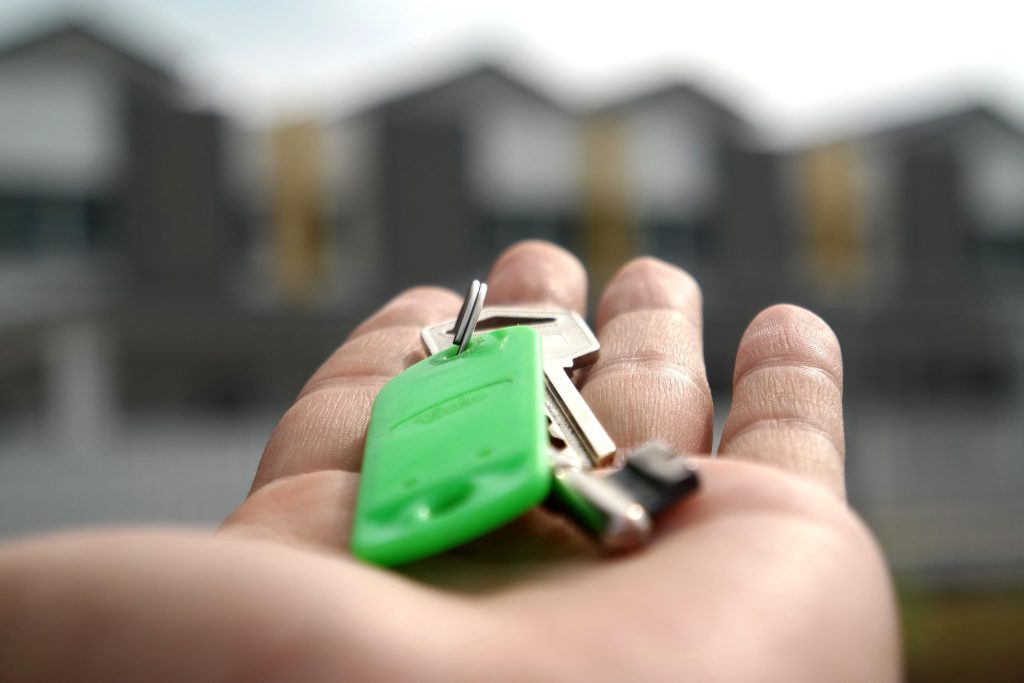 airbnb property owner handing over the key to property management host